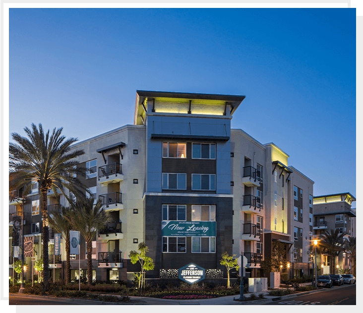 A large building with palm trees in the background.