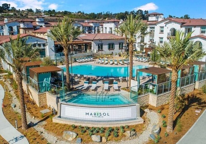 A resort pool with many chairs and umbrellas.